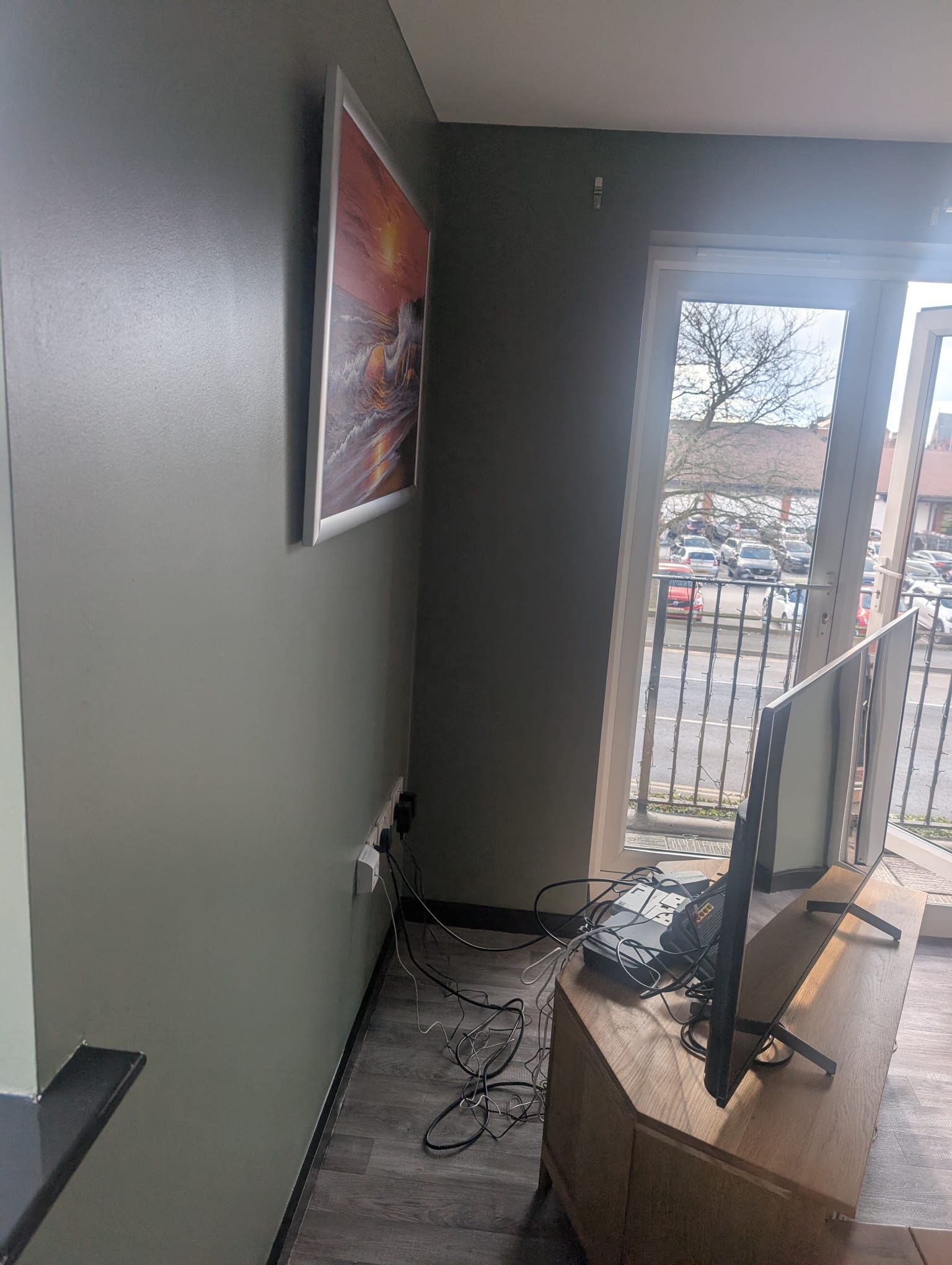 Commercial room with dark sage walls and artwork