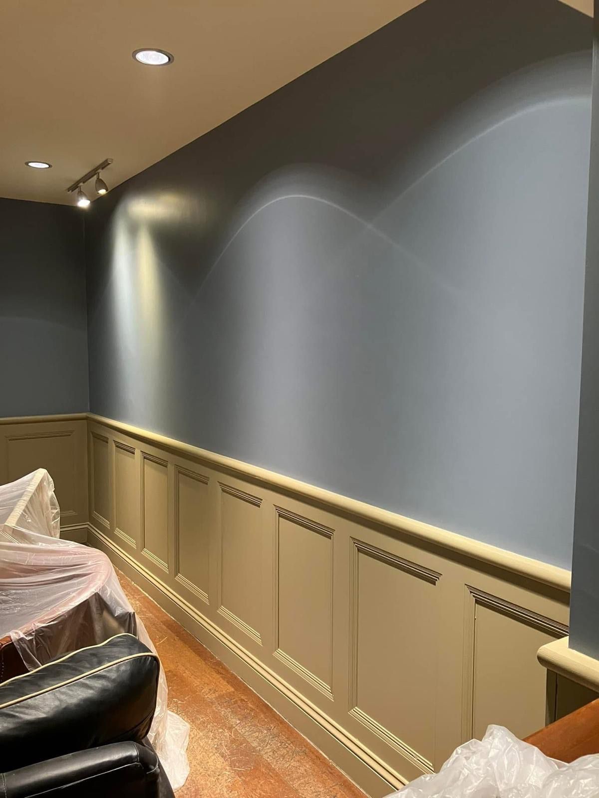 Dark blue walls with olive green wainscot panelling