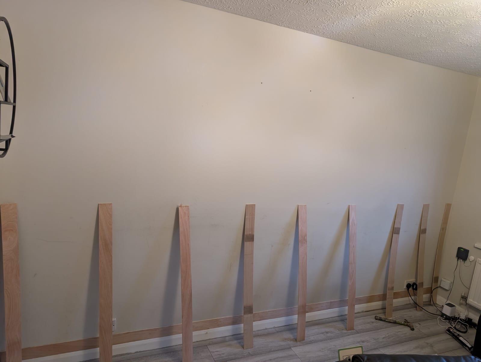 Bare timber battens being fitted to wall